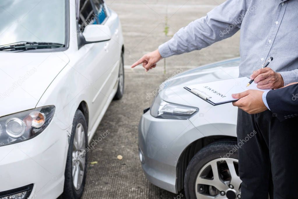 Insurance Agent examine Damaged Car and filing Report Claim Form