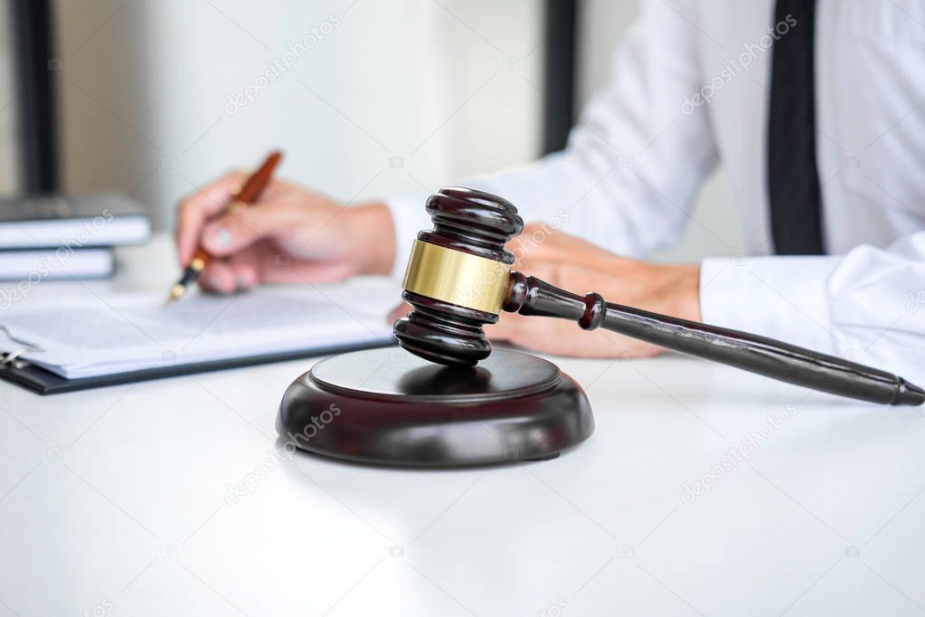 Businessman or lawyer working on a documents, judge gavel with J