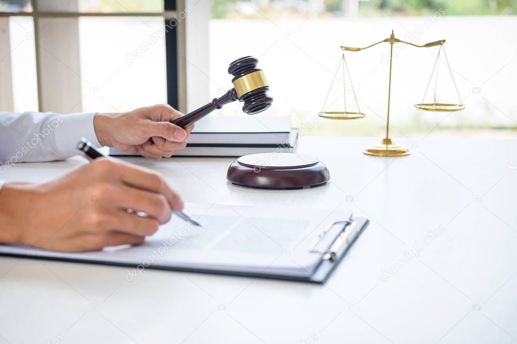 Businessman or lawyer working on a documents, judge gavel with J