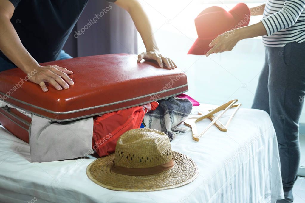 Travel and vacation concept, happiness young man packing a lot o