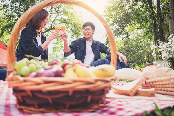Casal apaixonado beber um suco de laranja e frutas no piquenique de verão , — Fotografia de Stock