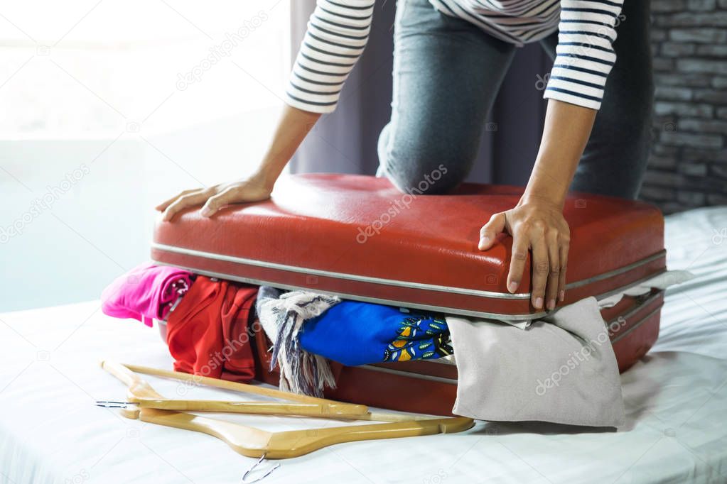 Travel and vacation concept, happiness young woman packing a lot