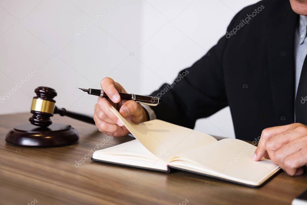 Judge gavel with scales of justice, male lawyers working having 