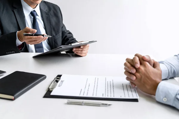 Senior committee manager reading a resume during a job interview — Stok fotoğraf