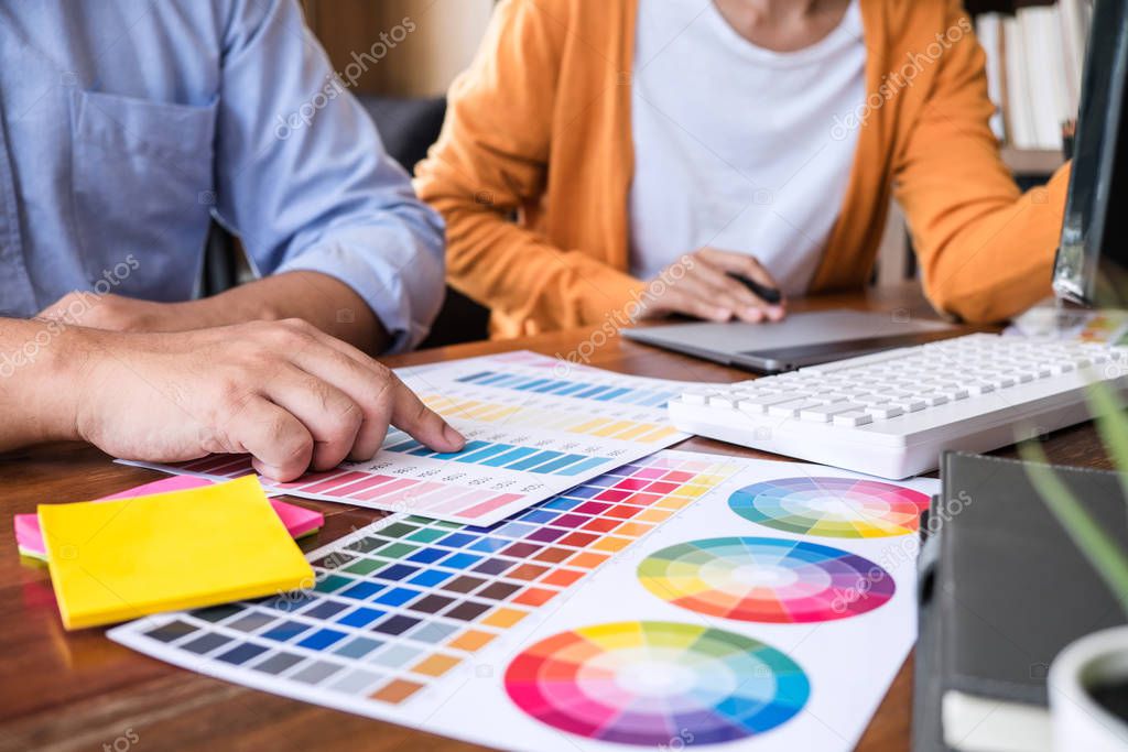 Two colleagues creative graphic designer working on color select