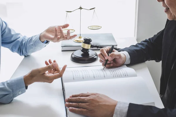 Consultation and conference of Male lawyers and professional businesswoman working and discussion having at law firm in office. Concepts of law, Judge gavel with scales of justice.