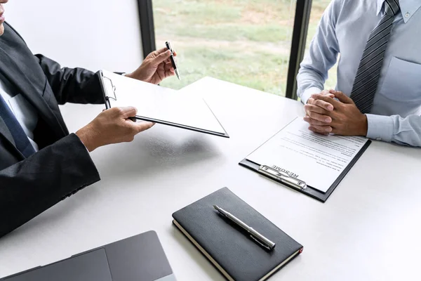 Senior committee manager reading a resume during a job interview — Stok fotoğraf