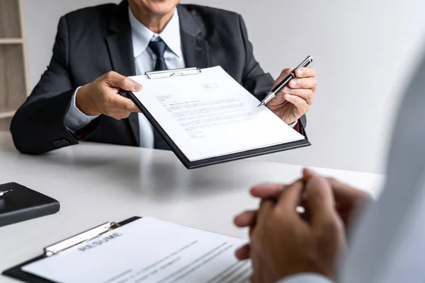 Senior committee manager reading a resume during a job interview — Stockfoto