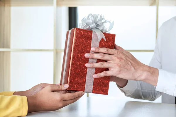 Couple giving gift box to each other with birthday greeting or celebration day and christmas.