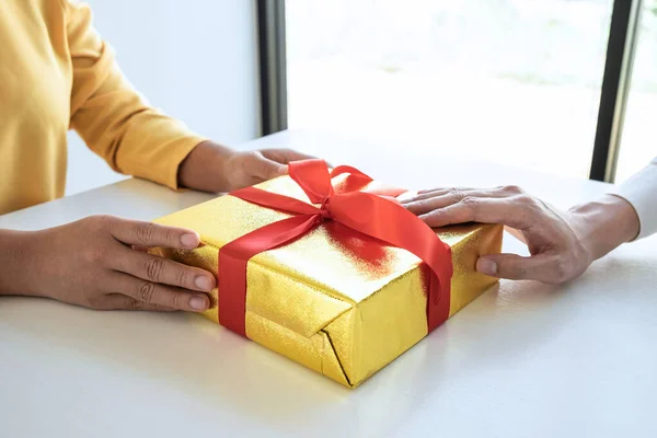 Couple giving gift box to each other with birthday greeting or celebration day and christmas.
