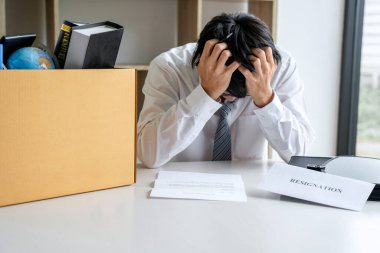 Tüm kişisel eşyalarını ve dosyalarını kahverengi bir karton kutuya koyan İşadamı, istifa etmek ve ofiste iptal sözleşmesi imzalamak için sinirlendi ve vurguladı..