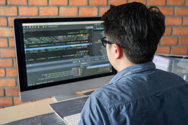 Bir yazılım geliştirme ofisinde çalışan, kod yazan ve veri kodu yazan, HTML, PHP ve javascript ile programlanan genç Profesyonel programcı.
