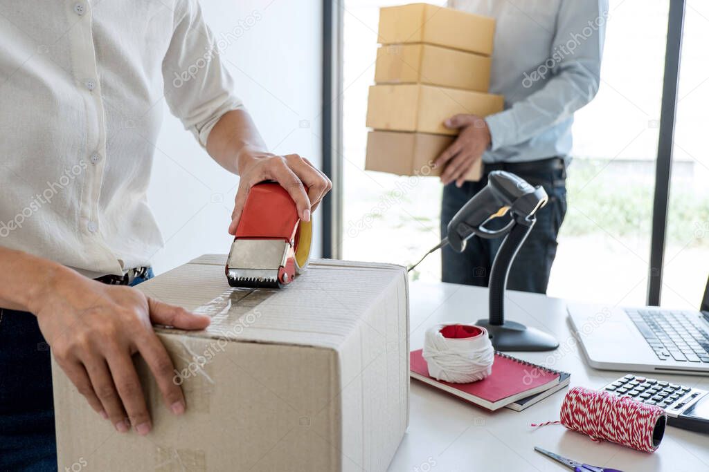 Young entrepreneur SME receive order client and working with packaging sort box delivery online market on purchase order and preparing package product, Small business parcel for shipment.