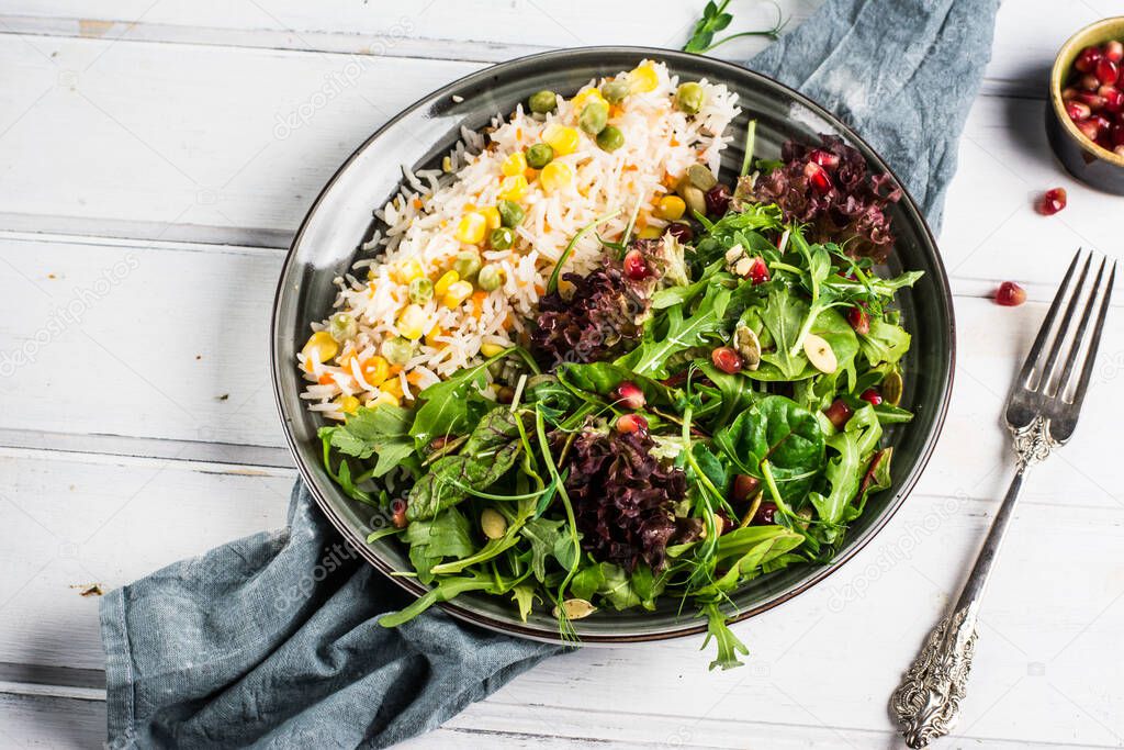 Wild rice, roasted corn buddha bowl. Vegetarian food concept. On a light background, top view. Fresh salad, ruccola, healthy food concept. Indian food. ramadan