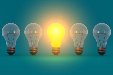 Idea concept glowing bulb on blue green background clipart