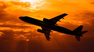 Gün batımı arka plan üzerinde uçan uçak silueti