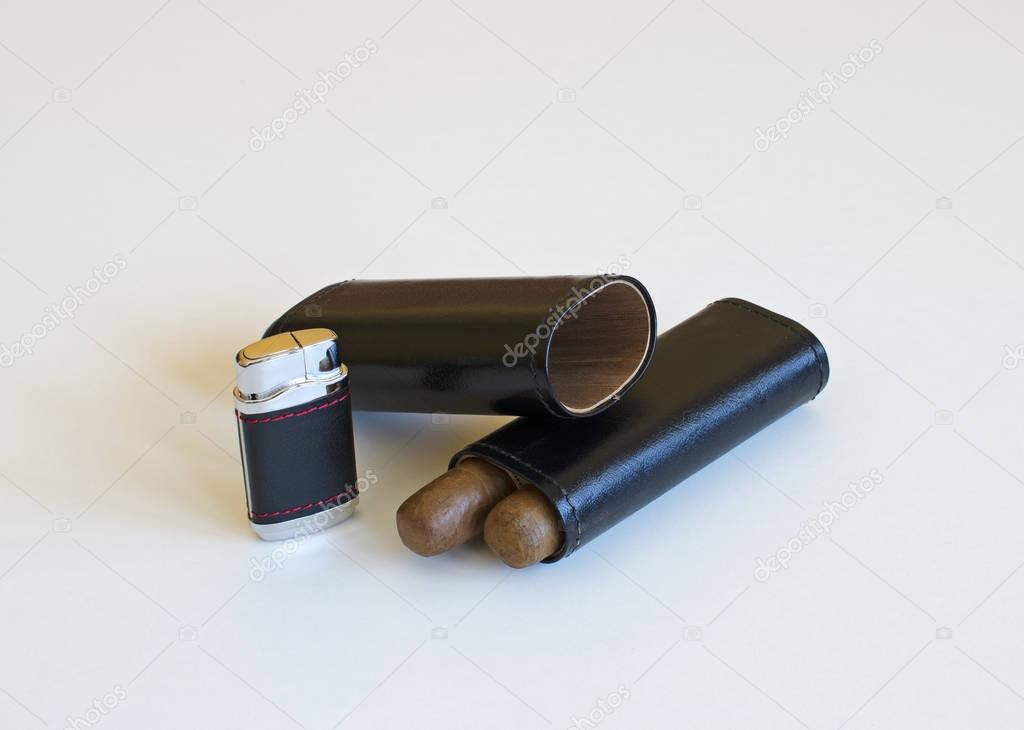 Still life with a cigar lighter and a leather case isolated on white background