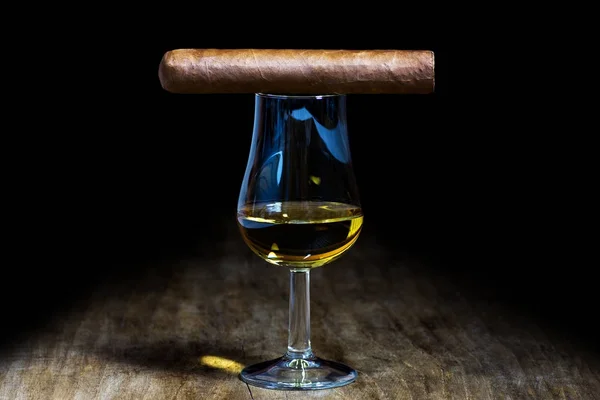 Un bicchiere di whisky con un sigaro — Foto Stock