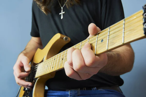 Jovem de camisa preta tocando guitarra elétrica — Fotografia de Stock