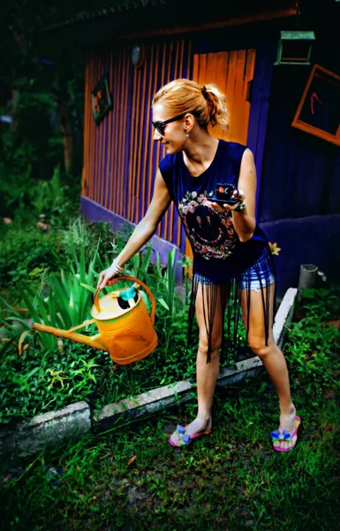 Girl watering flowers — Stock Photo, Image