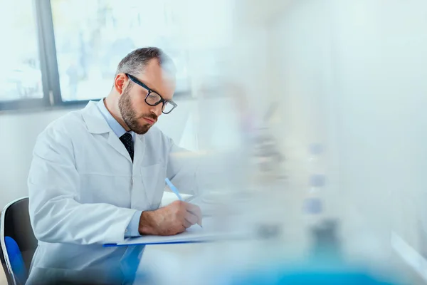 Medico che lavora presso il laboratorio di prova Foto Stock