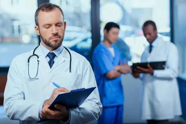 Confident doctor with folder — Stock Photo, Image