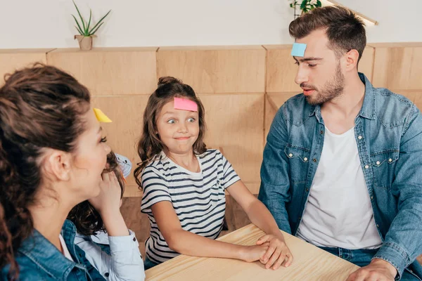 Family playing guess sticker — Stock Photo, Image