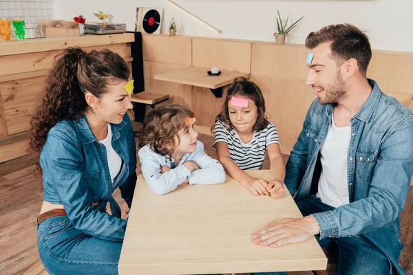 Family playing guess sticker — Stock Photo, Image