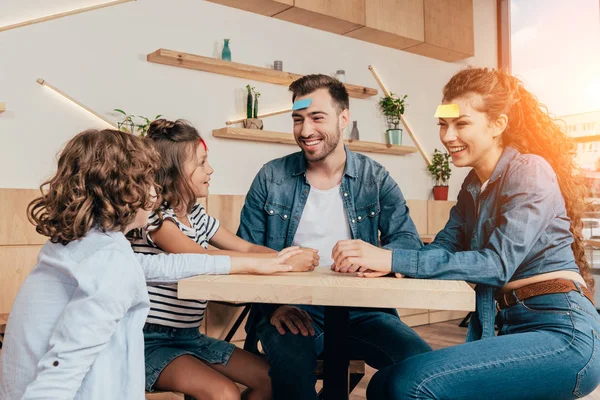 Family playing guess sticker — Stock Photo, Image