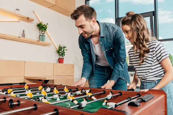 Father and daughter playing table football — Stock Photo, Image