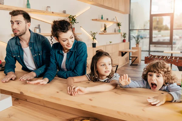 Beautiful young family in restaurant — Stock Photo, Image