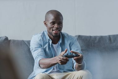 African american man playing with joystick clipart