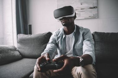 African american man using virtual reality headset clipart