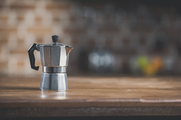 coffee pot on wooden table in kitchen