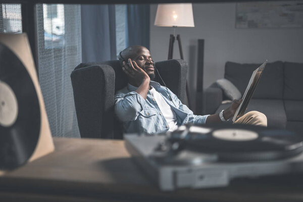 Man listening vinyl record