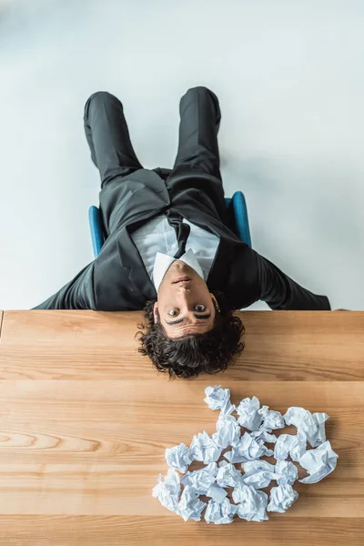 Businessman lying on table — Stock Photo, Image