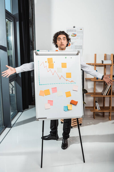 businessman near white board in office