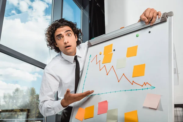 Businessman pointing at white board — Stock Photo, Image