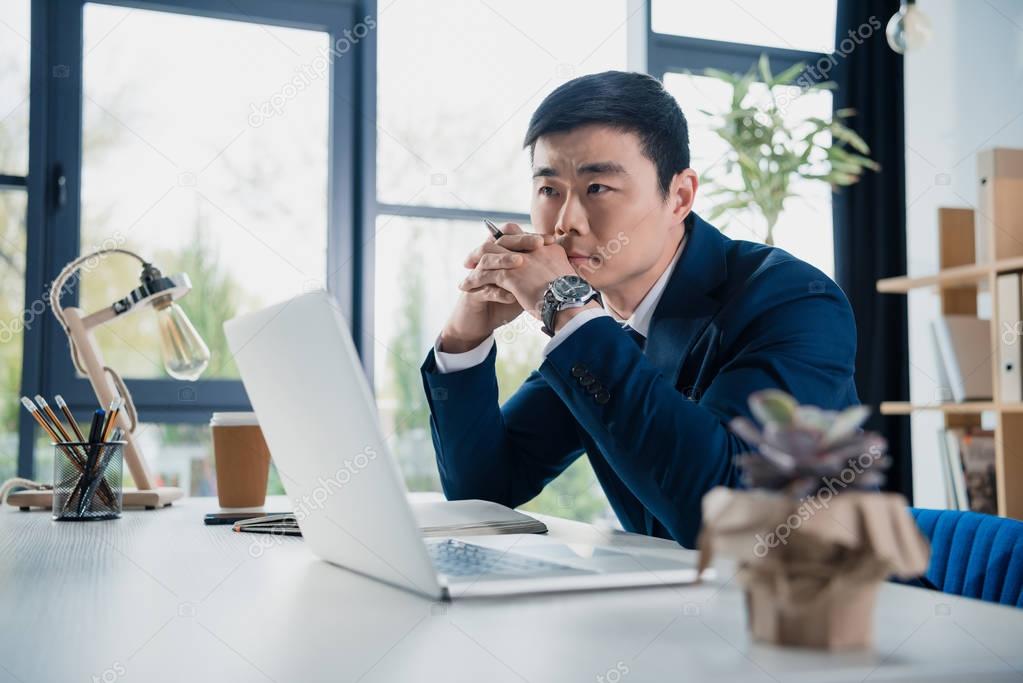 focused young asian businessman