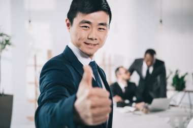 asian businessman showing thumb up