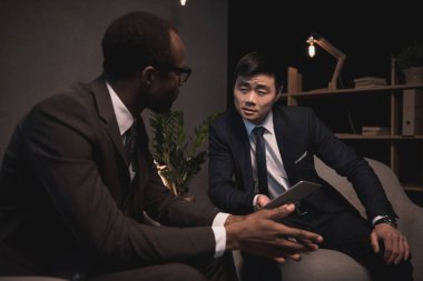 multiethic businessmen having conversation clipart
