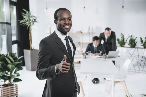 Black businessman showing thumb up — Stock Photo, Image