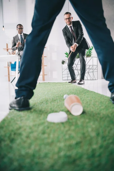 Бизнесмены играют в мини-гольф — стоковое фото