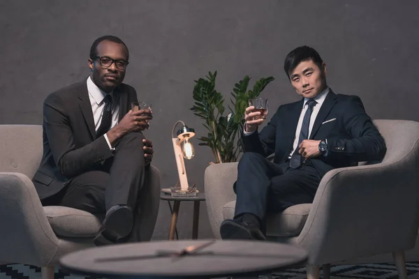 Multiethic businessmen relaxing on armchairs — Stock Photo, Image