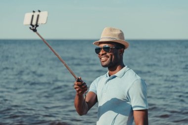 man taking selfie on beach clipart