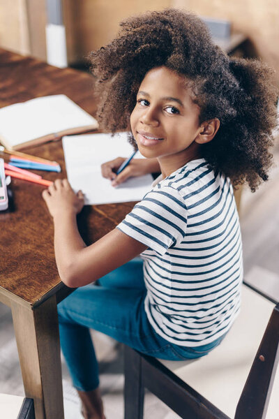 Little girl with pen and notebook