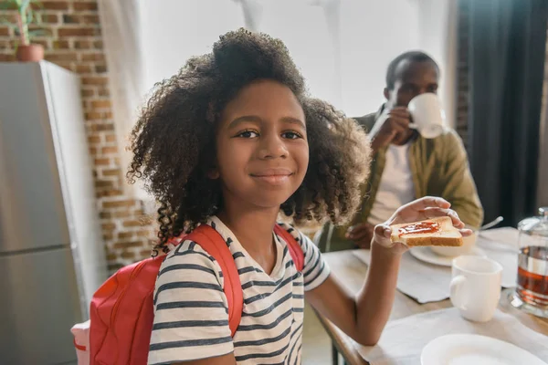 Reçelli ekmek yiyen küçük kız