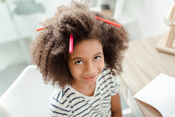 Little girl with markers in hair