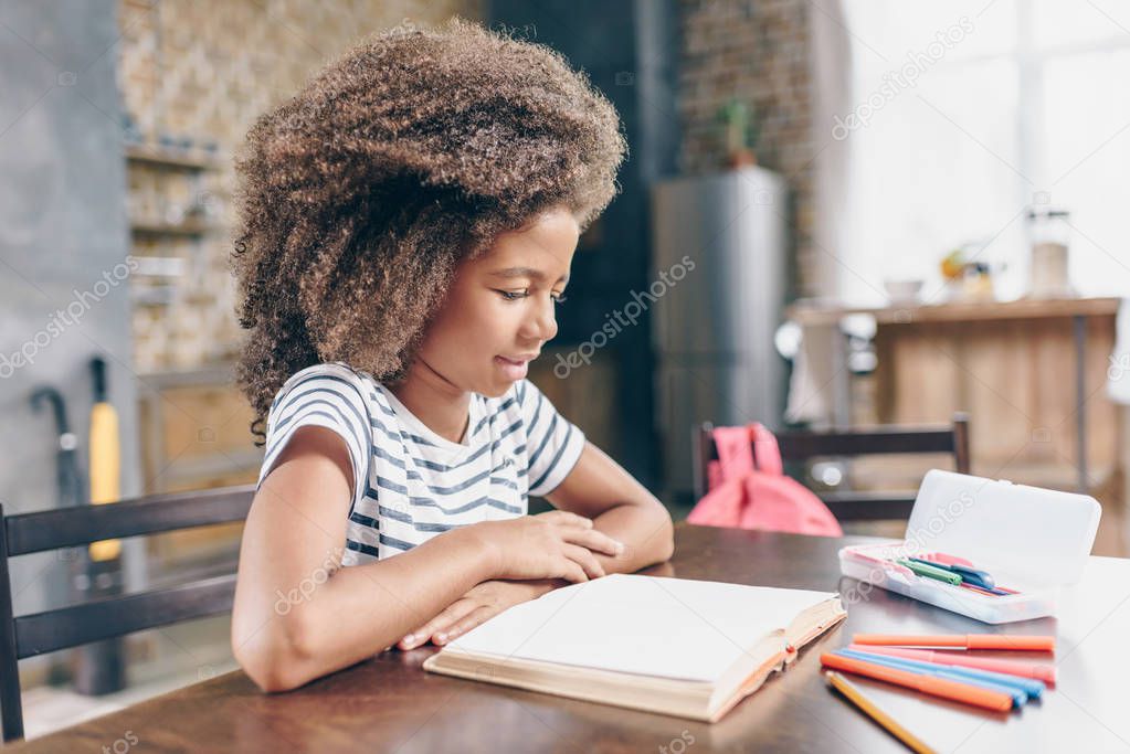 Little girl reading book