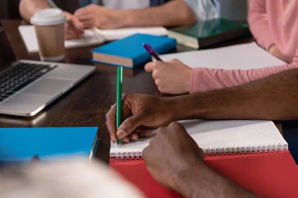 Students writing in copybooks — Stock Photo, Image
